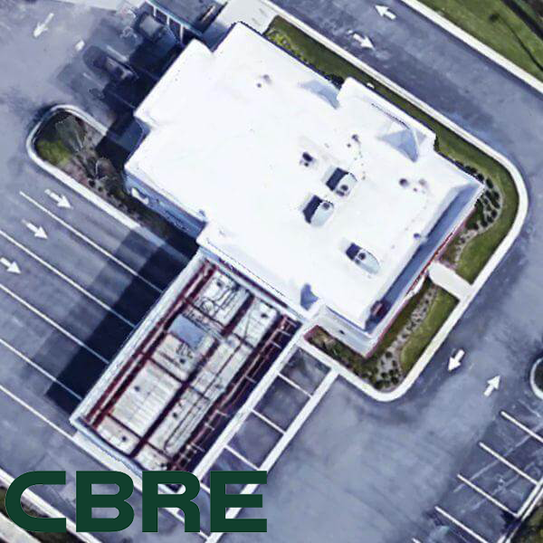 Ariel view of a commercial roof and parking lot