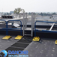 Blue rooftop safety railing with Danone logo overlay