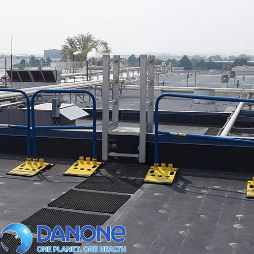 Blue rooftop safety railing with Danone logo overlay