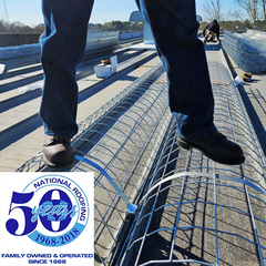 Worker demonstrating weight capacity of Safety Rail Source Model SSS NextGen Skylight Safety-Screen at National Roofing Corp in Suffolk, VA.