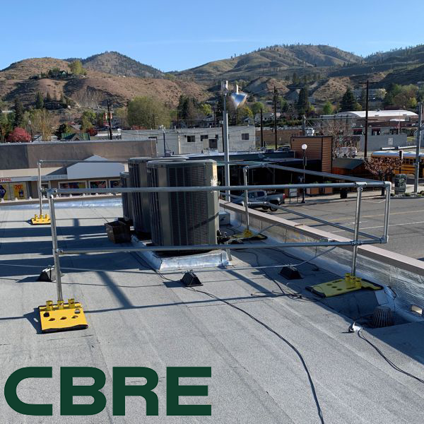Rooftop safety railing surrounding equipment