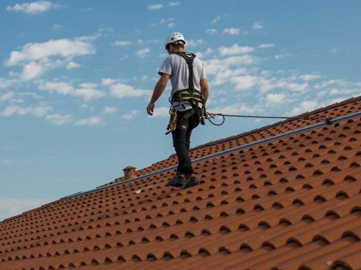 Worker using horizontal lifeline system for fall protection