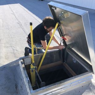 Man installing Lift and Lock Roof Hatch Opener