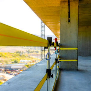 NextGen Tensioned WebRail passive guardrail system installed on a high-rise construction site