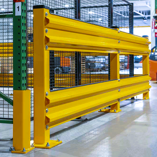 A bright yellow industrial safety guardrail with black mesh fencing, installed in a warehouse or factory setting.