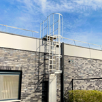 NextGen Mighty-Lite Fixed Ladder - Attached to a building exterior with a clear blue sky.