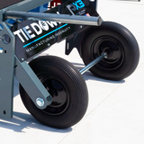 Close-up of a tie-down PX3 system with wheels on a white background