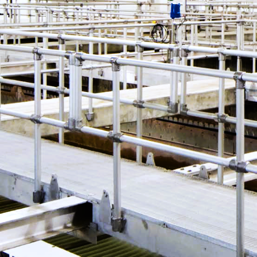 Custom railing mounted to walkways in a factory