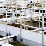 Custom railing mounted to walkways in a factory