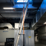 Industrial setting with metallic structures and machinery in a warehouse or factory.
