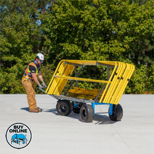 Person moving a yellow metal frame on a concrete surface with greenery in the background